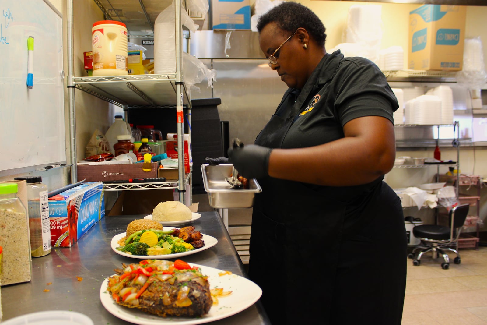 SOSO Cuisine owner Solange Asingabona also leads the kitchen of her restaurant, working alongside her son Angelo Ihirwe to prepare East African dishes inspired by her Rwandan roots.