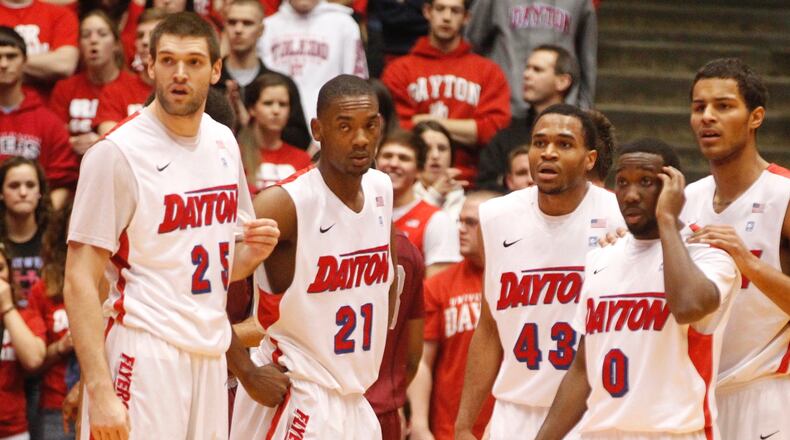 Dayton's Alex Gavrilovic, Dyshawn Pierre, Vee Sanford, Khari Price and Devin Oliver look to the bench for instruction during a game against Saint Joseph's on Wednesday, Jan. 29, 2014, at UD Arena. David Jablonski/Staff