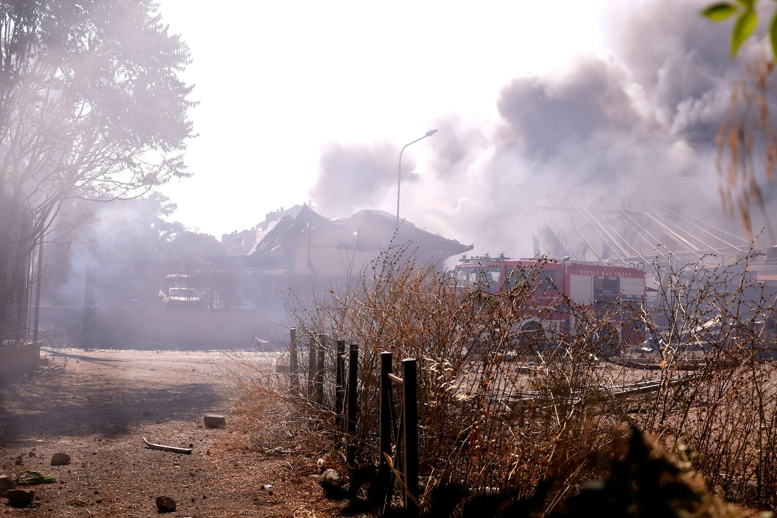 Firefighters work as smoke rises after a gas station exploded on the outskirts of Rome, Friday, July 4, 2025. (Cecilia Fabiano/LaPresse via AP)