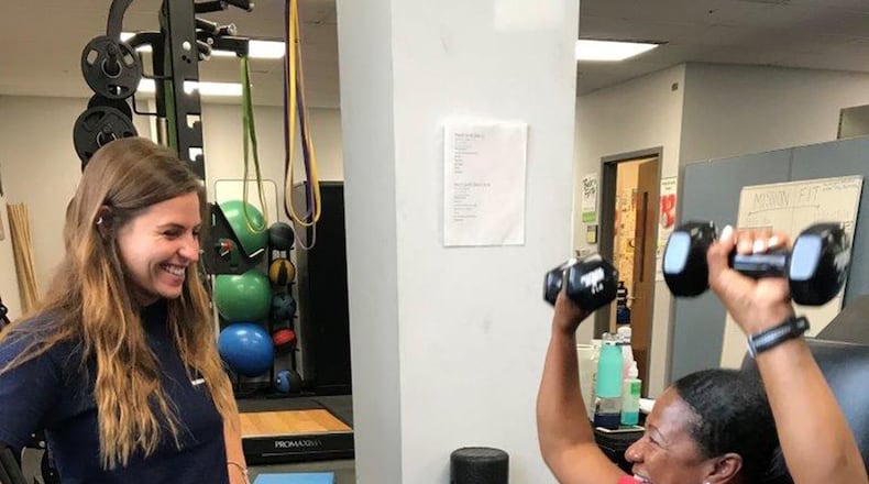 Ashley Kessler (left), United States Air Force School of Aerospace Medicine research athletic trainer, coaches Maj. Pamela Paulin, USAFSAM Public Health consultant, during her training session. (U.S. Air Force photos/Stacey Geiger)