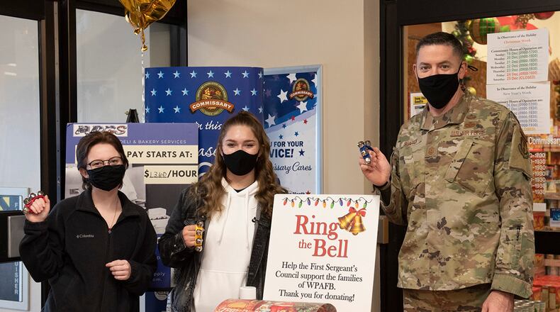 Chief Master Sgt. Jason Shaffer, 88th Air Base Wing command chief, rings bells with Senior Airmen Andrea Christensen (left) and Paige Hughes to draw attention to the First Sergeants Council’s “Ring the Bell” campaign Dec. 10 at Wright-Patterson Air Force Base. All money goes to the council’s Operation Warm Heart fund and is used to provide financial relief to Airmen during the holidays and throughout the year. U.S. AIR FORCE PHOTO/JAIMA FOGG