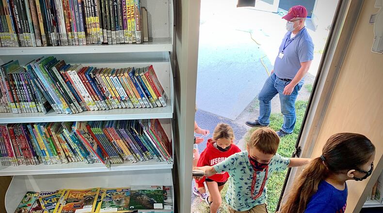 Students at Greeneview Elementary School in Jamestown enter the new Greene County Bookmobile on Tuesday, Sept. 14, 2021. MARSHALL GORBY\STAFF