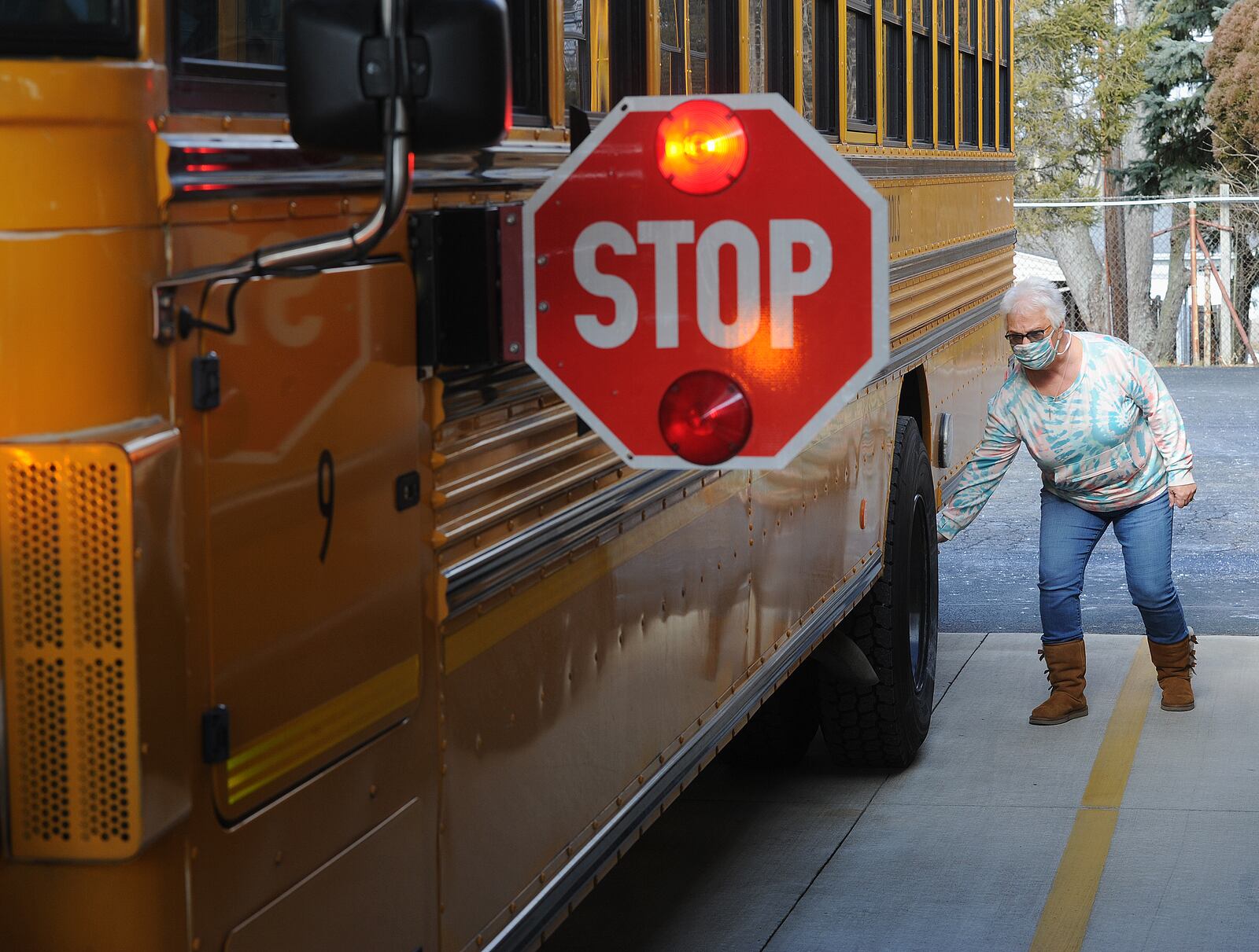 Carol Huff, a bus driver for the Kettering school districts for 37 years, checks over her bus before traveling on her route.  Huff has a daily checklist to make sure the bus is safe. MARSHALL GORBY\STAFF