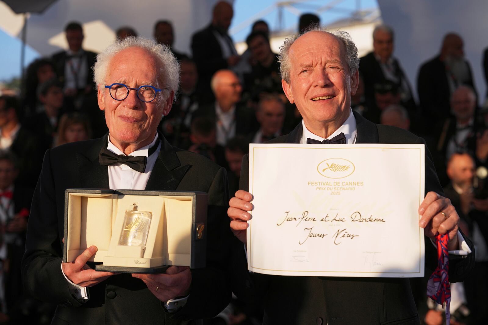 Directors Jean-Pierre Dardenne, left, and Luc Dardenne, winners of award for best screenplay for 'Jeunes Meres,' pose for photographers at the awards ceremony photo call at the 78th international film festival, Cannes, southern France, Saturday, May 24, 2025. (AP Photo/Natacha Pisarenko)