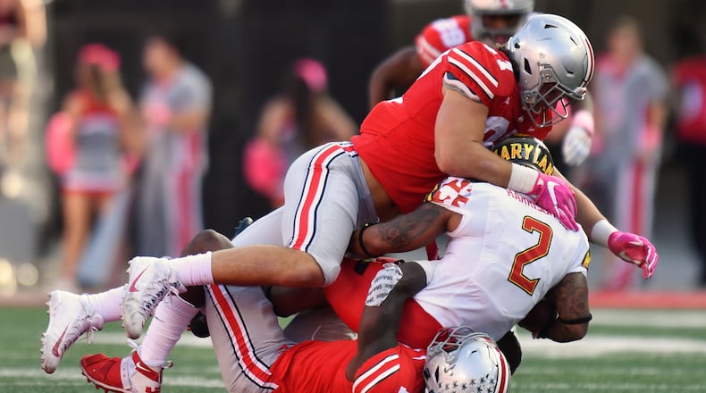 COLUMBUS, OH - OCTOBER 7:  Nick Bosa #97 of the Ohio State Buckeyes and Jerome Baker #17 of the Ohio State Buckeyes smother ballcarrier Lorenzo Harrison III #2 of the Maryland Terrapins in the second quarter at Ohio Stadium on October 7, 2017 in Columbus, Ohio.  (Photo by Jamie Sabau/Getty Images)