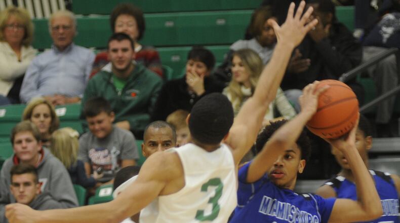 Miamisburg’s Lathan Hartman (with ball) is checked by Northmont’s Christian Wilson. Northmont defeated visiting Miamisburg 74-71 in a boys high school basketball game on Friday, Dec. 16, 2016. MARC PENDLETON / STAFF