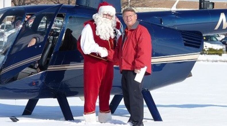 Santa Claus will be delivered by helicopter to visit the Dayton Mall Skyline Chili at 8906 Kingsridge Drive for a meet-and-greet event with families from noon to 2 p.m. on Saturday, Dec. 7. In this submitted 2017 photo, Santa is shown with Mark Keilholz, franchise owner of the Kingsridge Drive Skyline restaurant.