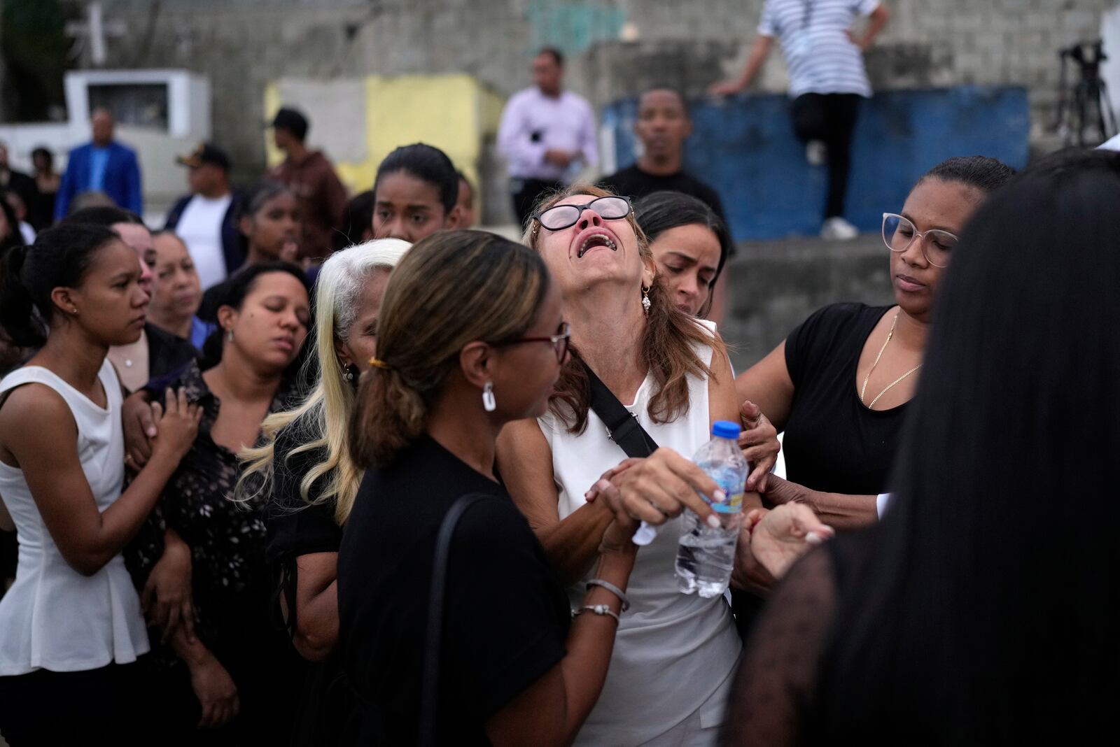 FILE - Family and friends grieve during the burial service for Marilenny Pilarte who died at the Jet Set nightclub when its roof collapsed, in Haina, Dominican Republic, April 10, 2025. (AP Photo/Matias Delacroix, File)