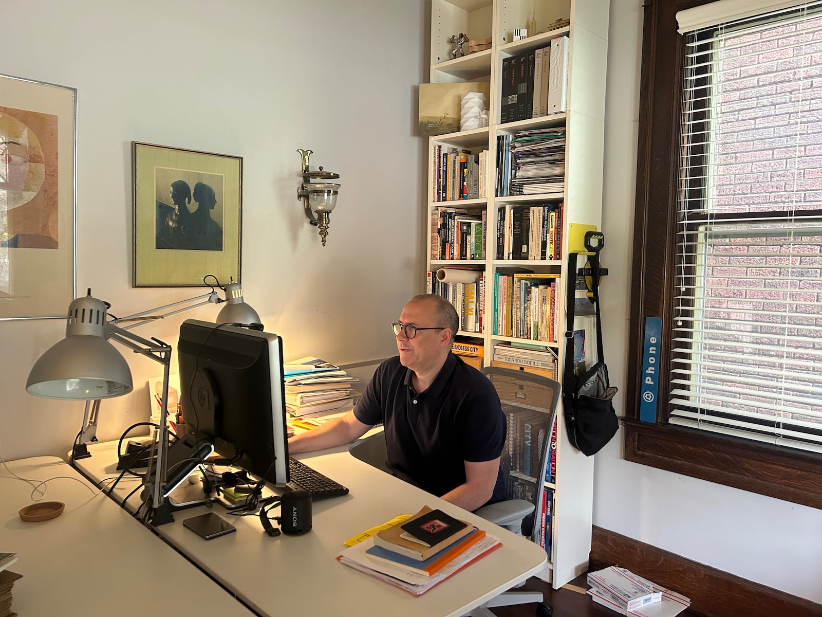 Matt Sauer, architect, works on blueprints in his Grafton Hill home office. HANNAH KASPER/CONTRIBUTED