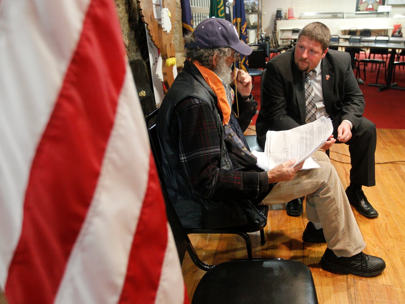 Army veteran Lawrence Woodward Franzheim III talks with Lee Martin, a military/veterans case worker