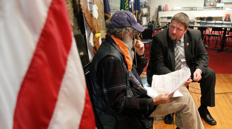 Army veteran Lawrence Woodward Franzheim III talks with Lee Martin, a military/veterans case worker, during a free veterans' benefits forum Thursday, Nov. 8, 2012, at the Veterans of Foreign Wars Post 1031 in Springfield, hosted by the office of U.S. Rep. Steve Austria, R-Beavercreek. Austria's congressional district-- the current 7th Congressional District of Ohio, which includes Clark and Greene counties--is home to more veterans than any other in the state. Barbara J. Perenic/Springfield News-Sun