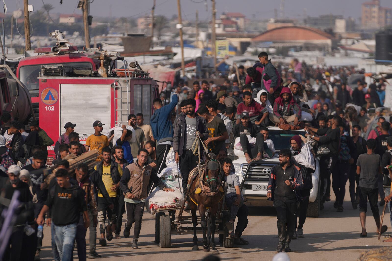 Palestinians carry boxes and bags containing food and humanitarian aid packages delivered by the Gaza Humanitarian Foundation, a U.S.-backed organization approved by Israel, in Khan Younis, southern Gaza Strip, Sunday, June 1, 2025. (AP Photo/Abdel Kareem Hana)