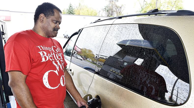 James Moore fills up his van at the Valero gas station on St. Paris Pike Tuesday. Compared to this time last year, Americans have an extra $110 million a day in their pockets they’re not spending on gas, according to GasBuddy.com, which watches prices at more than 133,000 stations in the U.S. and surveyed 391 area stations. Bill Lackey/Staff