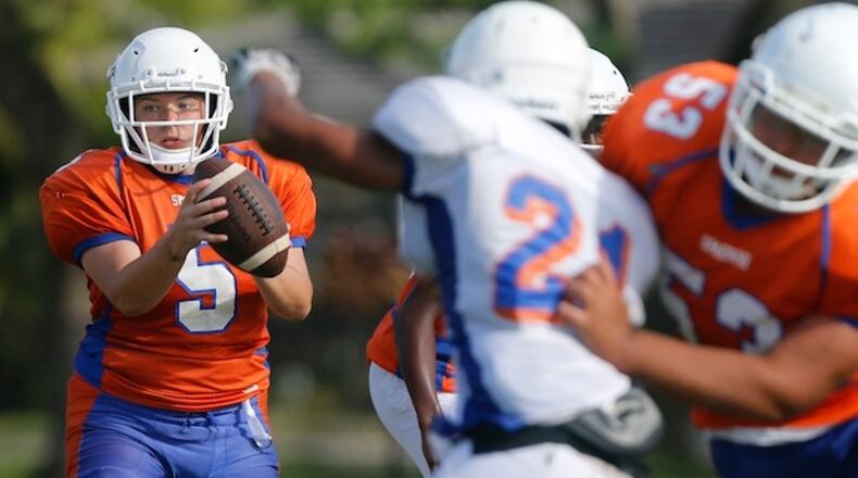 Hollywood Hills quarterback Holly Neher, 16, looks for an open receiver during a scrimmage game. (Carl Juste/Miami Herald/TNS)