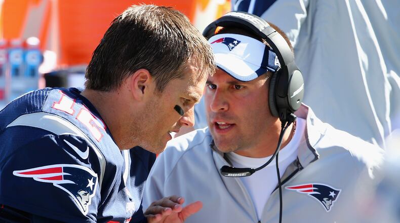 Josh McDaniels, offensive coordinator for the New England Patriots congratulates Tom Brady #12 of the New England Patriots after his 400th career touchdown pass during the first half against the Jacksonville Jaguars at Gillette Stadium on September 27, 2015 in Foxboro, Massachusetts. (Photo by Maddie Meyer/Getty Images)