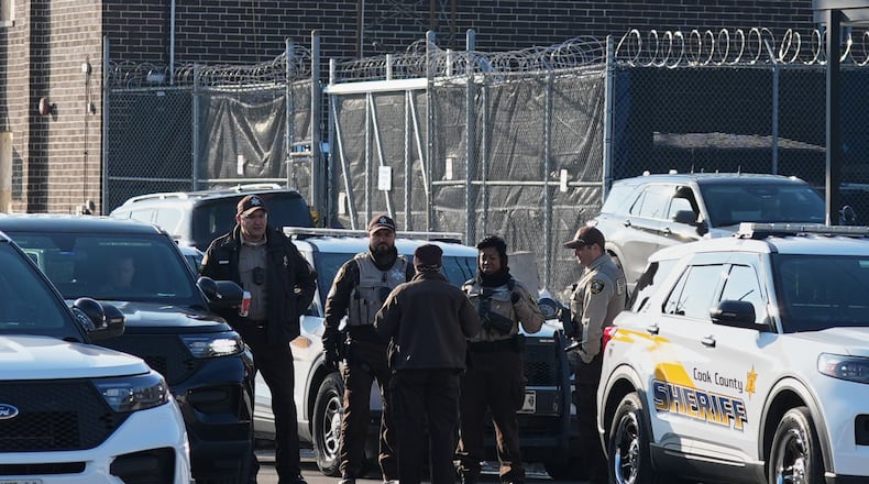Law enforcement officers guard as protesters gather outside an ICE processing facility in the Chicago suburb of Broadview, Ill., Friday, Dec. 12, 2025. (AP Photo/Nam Y. Huh)