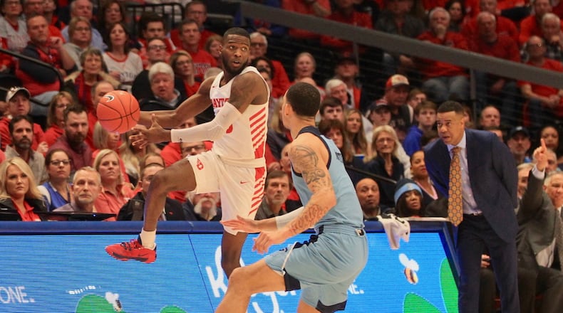 Jalen Crutcher jumps to throw a pass against Rhode Island in Dayton's win over the Rams on Tuesday night at UD Arena.