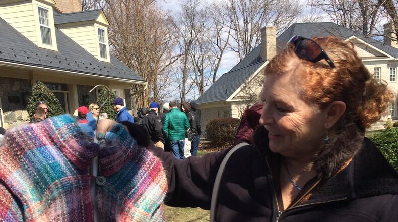 Nina Harris of Glenn Dale, Md., displays a shawl she bought at the estate sale for John and Annie Glenn. Photo by Jessica Wehrman.