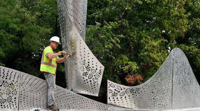 “Foliage,” a new Kettering public artwork, has been installed on the Ridgeway Road bridge. The stainless steel sculpture designed by Cliff Garten Studio in Venice, CA, mimics the landscape found within Hills & Dales MetroPark and Kettering. SHAYNA MCCONVILLE / CITY OF KETTERING