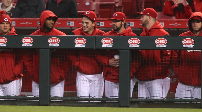 Reds players, including Amir Garrett, second from left, watch a game against the Giants on Friday, May 5, 2017, at Great American Ball Park in Cincinnati.