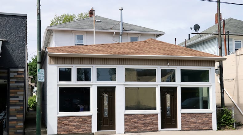 Retail or office space accents the front of this 2-story home. The house has 3 bedrooms and spacious first-floor social areas on a full basement. The store-front offers two separate rooms and a half bath and has been updated with a roof, entrance doors and flooring. CONTRIBUTED PHOTO BY KATHY TYLER