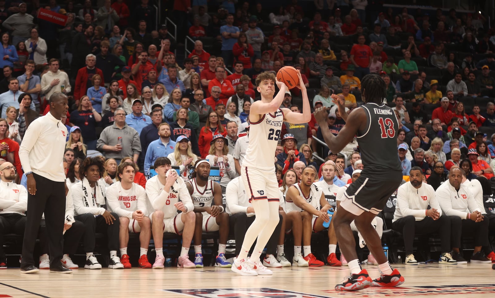 Dayton's Amaël L'Etang makes a game-tying 3-pointer in the second half against Saint Joseph’s on Friday, March 14, 2025, in the quarterfinals of the Atlantic 10 Conference tournament at Capital One Arena in Washington, D.C. David Jablonski/Staff