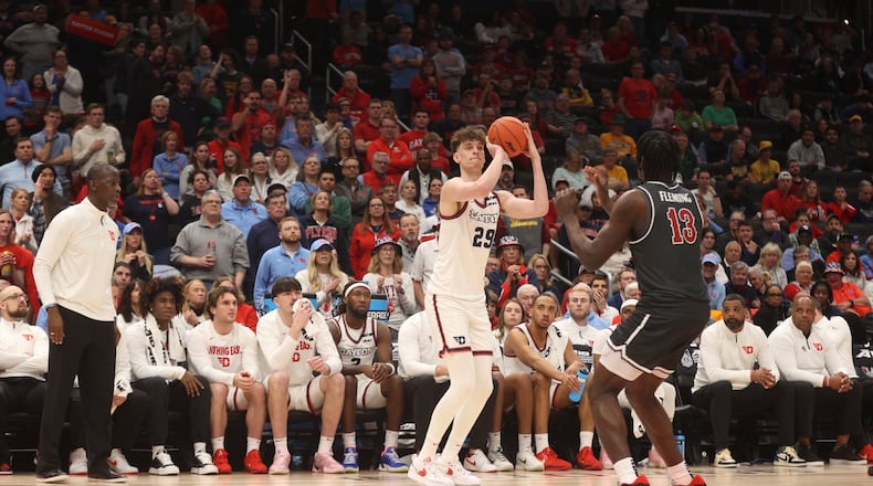Dayton's Amaël L'Etang makes a game-tying 3-pointer in the second half against Saint Joseph’s on Friday, March 14, 2025, in the quarterfinals of the Atlantic 10 Conference tournament at Capital One Arena in Washington, D.C. David Jablonski/Staff