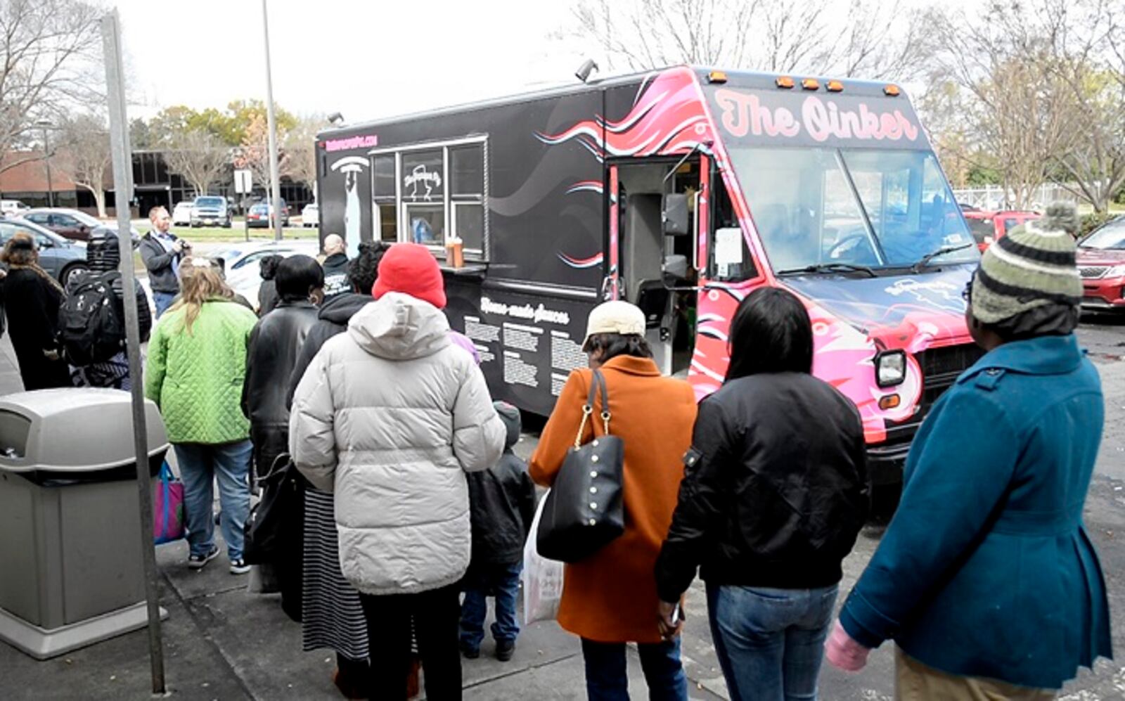 Women line up at The Improper Pig's food truck, The Oinker, to receive lunch outside the Salvation Army's Center of Hope in Charlotte, N.C., on March 14, 2017. (David T. Foster III/Charlotte Observer/TNS)