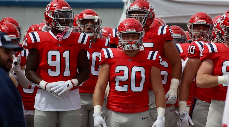 Dayton players, including Javson Harris-Woodard (91) and Cade Beam (20), wait to run onto the field before a game against Central State on Saturday, Sept. 9, 2023, at Welcome Stadium. David Jablonski/Staff