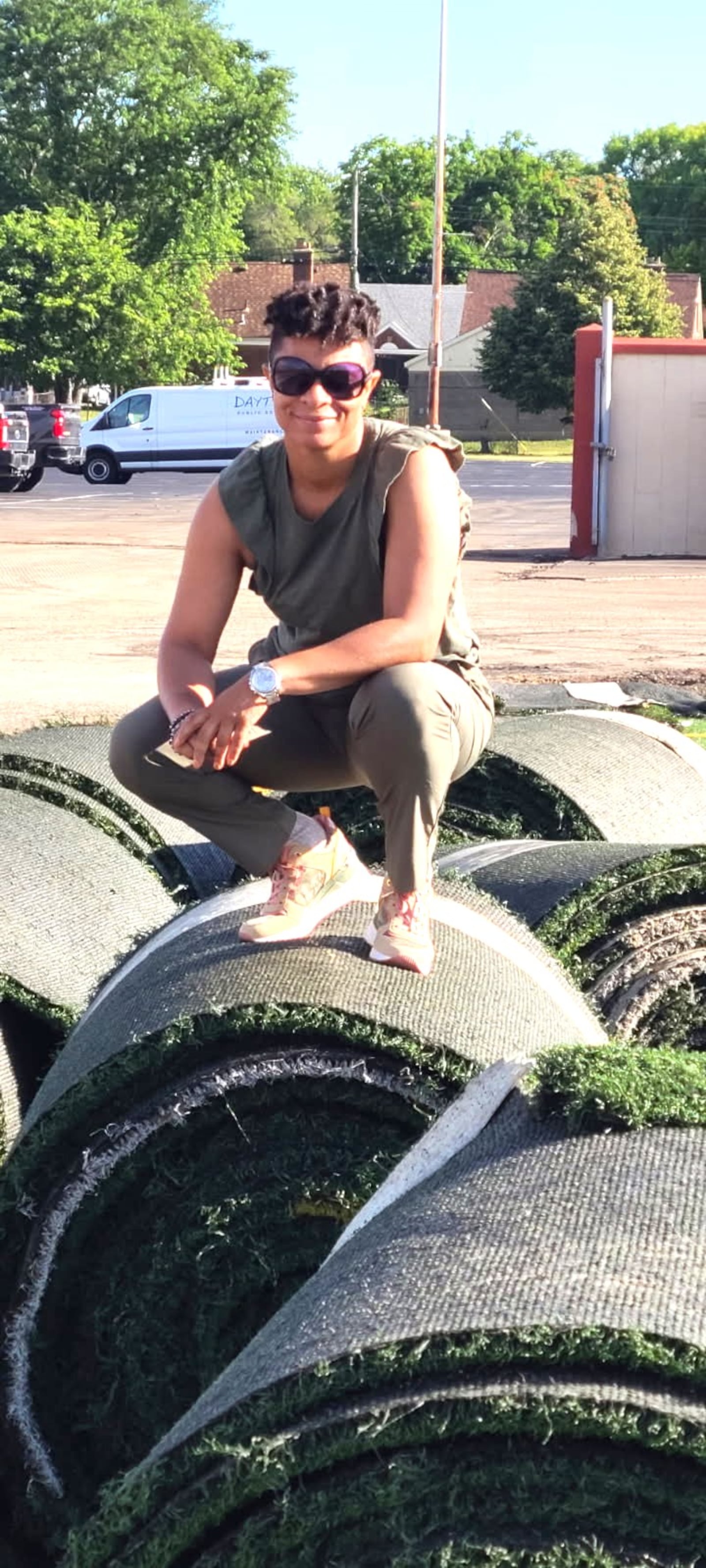Victoria Jones, the Director of Athletics for the Dayton Public Schools, stands on rolls of turf which were used in the $11 million renovation of Welcome Stadium which happened on her watch. CONTRIBUTED PHOTO