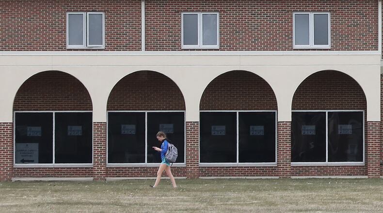 A student at Urbana University walks past the arches on one of the residence hall as she makes her way across on campus Bill Lackey/Staff