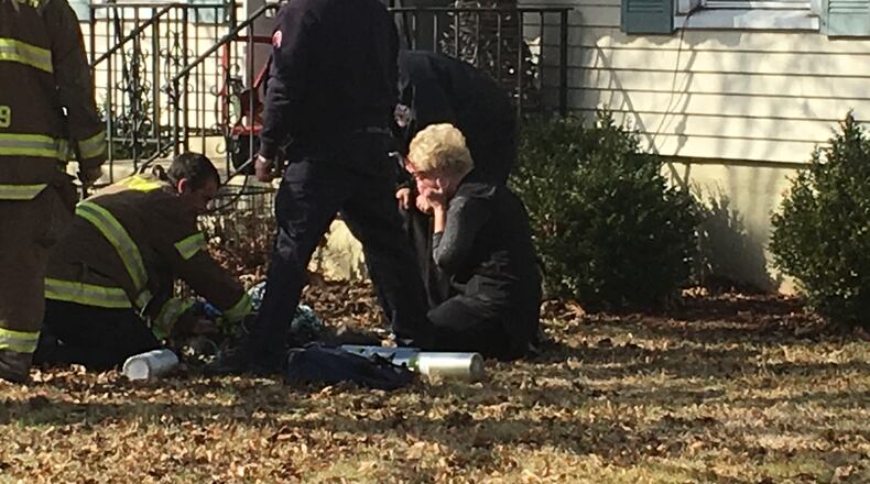 A woman is distraught as Middletown paramedics try to save her dog’s life. The dog apparently was trapped inside the burning home Friday morning on Bexley Drive. The dog was resuscitated and transported to a local veterinarian. RICK McCRABB/STAFF