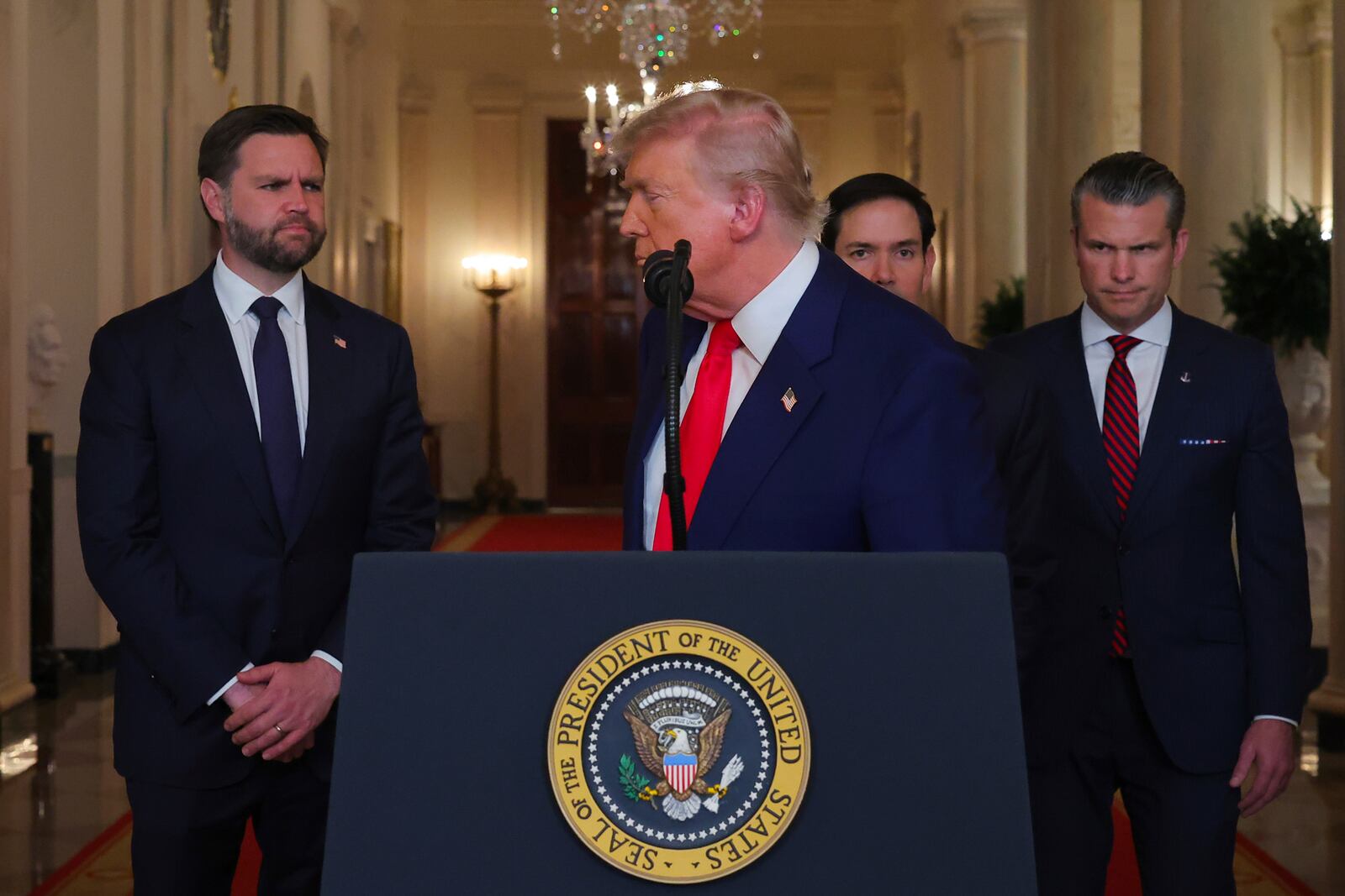 President Donald Trump turns from the podium after speaking from the East Room of the White House in Washington, Saturday, June 21, 2025, after the U.S. military struck three Iranian nuclear and military sites, directly joining Israel's effort to decapitate the country's nuclear program, as Vice President JD Vance, Secretary of State Marco Rubio and Defense Secretary Pete Hegseth listen. (Carlos Barria/Pool via AP)
