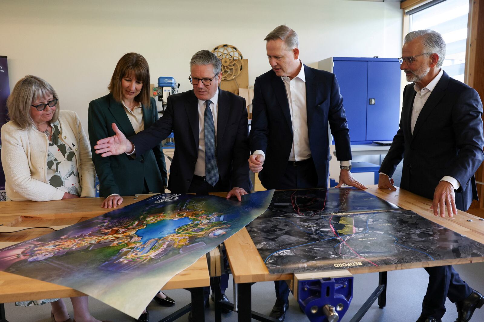 British Prime Minister Keir Starmer, centre, Chancellor of the Exchequer Rachel Reeves, second from left, President of Comcast Corporation Michael Cavanagh, Chief Executive of Bedford Borough Council Laura Church, left, and Chairman and CEO of Universal Destinations & Experiences Mark Woodbury, right, meet on the day of an announcement that U.S. media giant Comcast Corp will build its first Universal theme park and resort in Europe, opening in 2031, during a visit to Bedford, north of London, Wednesday April 9, 2025. (John Sibley/Pool Photo via AP)