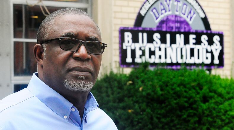 Don Jasmin, superintendent of the Dayton Business Technology High school, a dropout prevention charter school in West Dayton, stands in front of the building. The Dayton Business Technology High School received a $172,000 state grant to expand their career technology offerings. Marshall Gorby/ Staff