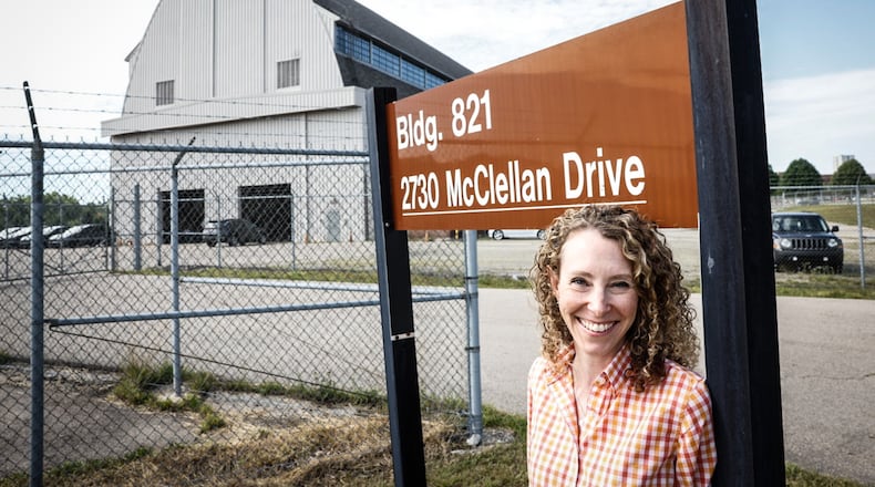 Rachel Butt is the president of Butt Construction, and her grandfather built the radar building, the building in the background, on Wright Patterson Air Force Base. Known as "the Barn," the structure was originally purpose-built to study radar technology in 1947, and its every design choice was made with research in mind, the base has said. The structure runs 200 feet in length, with 13 arches spanning 80 feet and supporting the roof 78 feet above.JIM NOELKER/STAFF