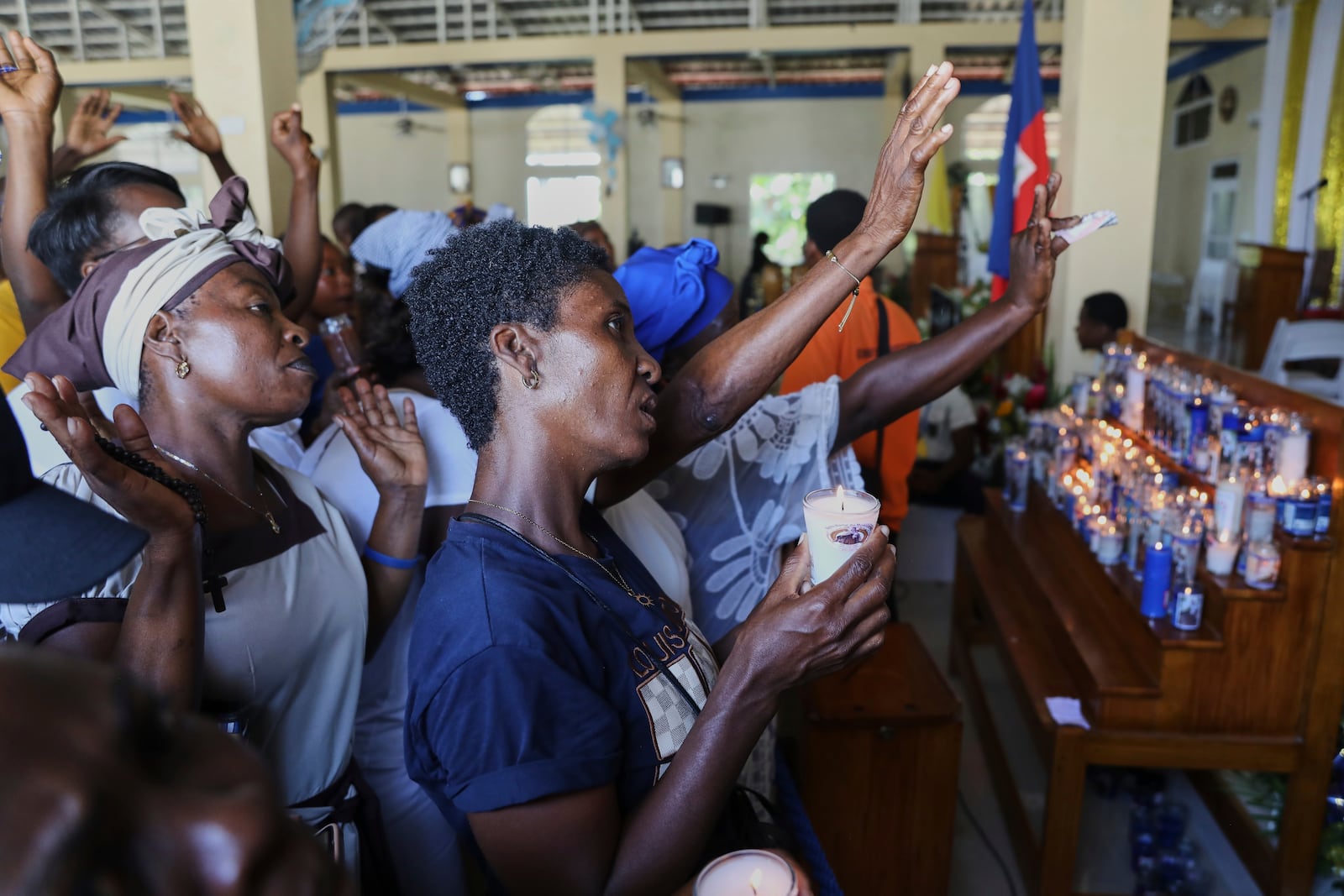 Pilgrims pray during a Mass celebrating the Feast of Our Lady of Mount Carmel at the namesake church in the Pétion-Ville neighborhood of Port-au-Prince, Haiti, on Wednesday, July 16, 2025. (AP Photo/Odelyn Joseph)