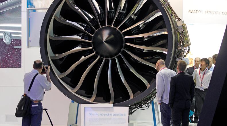 In this 2013 file photo, visitors watch General Electric’s GEnx engine at the Paris Air Show at Le Bourget airport, north of Paris. AP