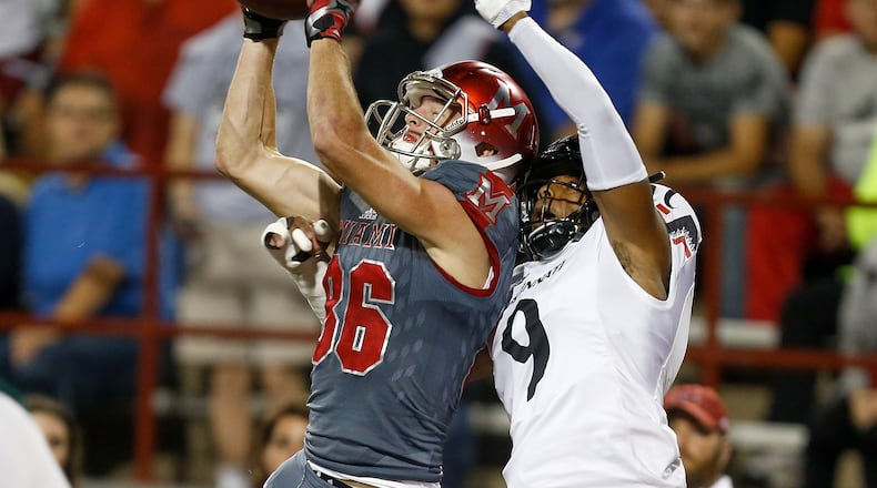 Luke Mayock #86 of the Miami Ohio Redhawks catches a touchdown defended by Linden Stephens #9 of the Cincinnati Bearcats during the first half at Yager Stadium on September 16, 2017 in Oxford, Ohio. (Photo by Michael Reaves/Getty Images)