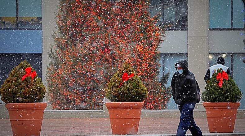 A little snowfall on Christmas Eve day at Courthouse Square in Dayton. MARSHALL GORBY\STAFF