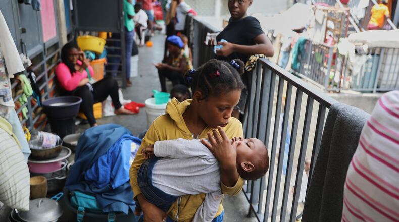 A girl pacifies a toddler at a shelter for families displaced by gang violence, in Port-au-Prince, Haiti, Thursday, May 22, 2025.(AP Photo/Odelyn Joseph)