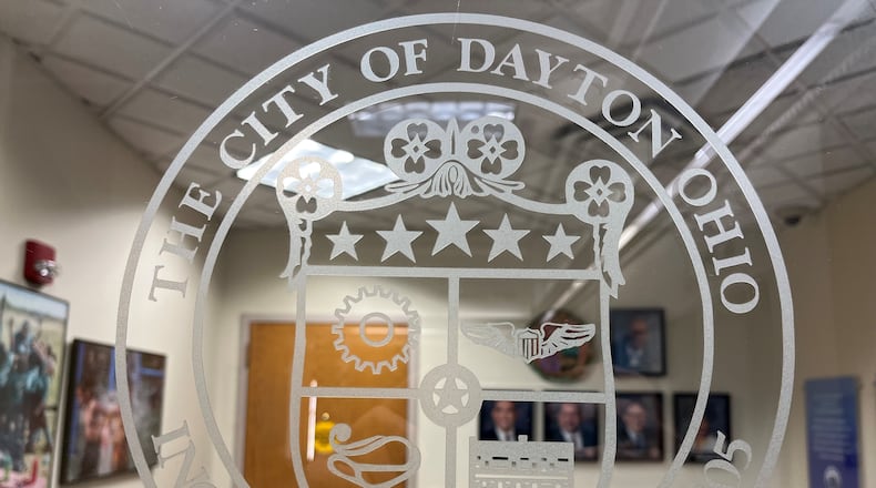 The city of Dayton seal on the door to the offices of the Dayton City Commission. Two commission seats will be up for grabs later this year. CORNELIUS FROLIK / STAFF