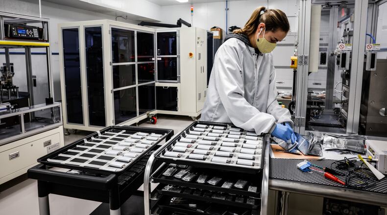 Lectratek researcher Jessica Krstic works in a lab with lithium batteries at the company's facility on Washington Church Road in Miami Twp. JIM NOELKER/STAFF