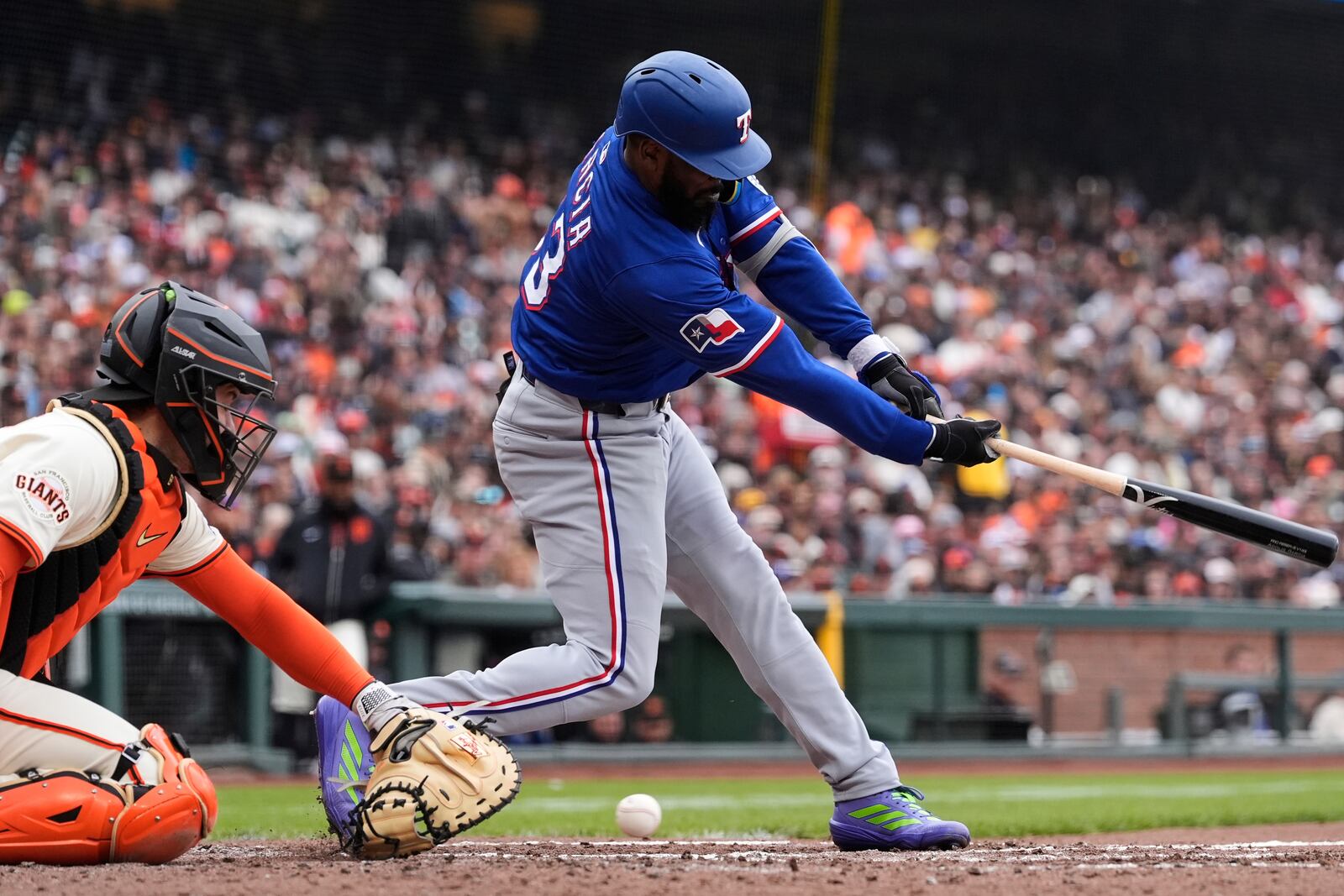 Texas Rangers' Adolis García, right, strikes out next to San Francisco Giants catcher Patrick Bailey during the sixth inning of a baseball game Sunday, April 27, 2025, in San Francisco. (AP Photo/Godofredo A. Vásquez)