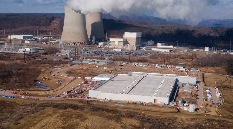 FILE - A data center owned by Amazon Web Services, front right, is under construction next to the Susquehanna nuclear power plant in Berwick, Pa., Jan. 14, 2025. (AP Photo/Ted Shaffrey, File)