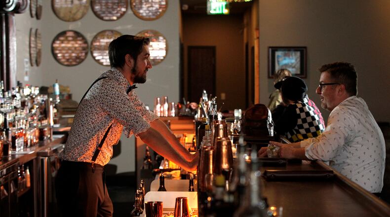 Daytonâs Century Bar has reopened in the three-story former Dayton Power and Light building, 18 S. Jefferson St. The historic cherry wood bar, the centerpiece of the original Century Bar, has been restored and installed in the new expanded space. Century Bar is co-owned by Diane Spitzig and Joseph Head.   LISA POWELL / STAFF