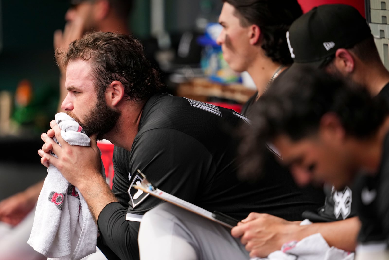 Chicago White Sox Bryse Wilson, left, looks on from the dugout during the fourth inning of a baseball game against the Cincinnati Reds, Thursday, May 15, 2025, in Cincinnati. (AP Photo/Jeff Dean)