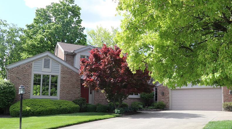 The brick 2-story sits diagonally on a corner lot with a curved driveway that leads to the 2-car garage. It is one of 7 units that encircle the rolling green space with a bridge and views of nearby NCR golf course. CONTRIBUTED PHOTO BY KATHY TYLER