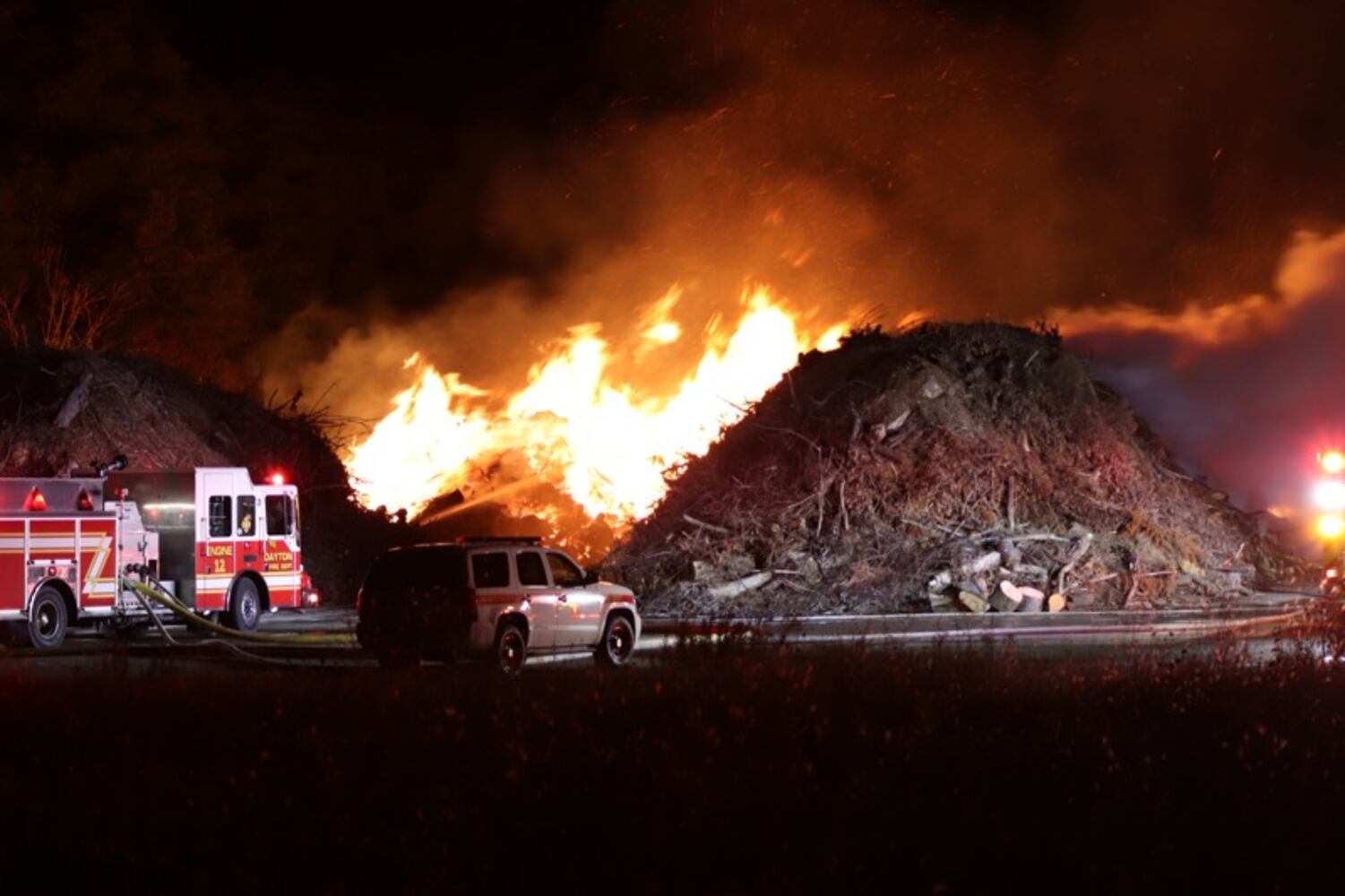 Fire crews battling huge fire in wood piles on Harshman Road
