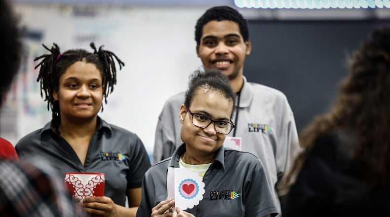 Belmont High School students from left, Joie Brewton, Deona McDonald and Devante Nash hold up Valentine cards they made at school Tuesday January 23, 2024. The three are part of a program called Project Life. JIM NOELKER/STAFF